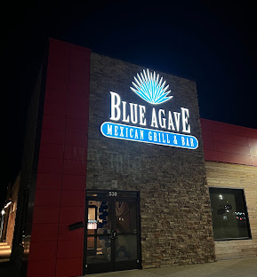 Blue Agave Mexican Grill & Bar storefront at 530 N Harrison Street, lit up at night.